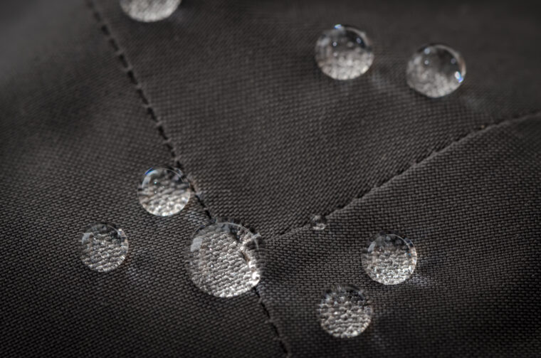 Grey Waterproof Jacket Detail – Close Up with Liquid Droplets